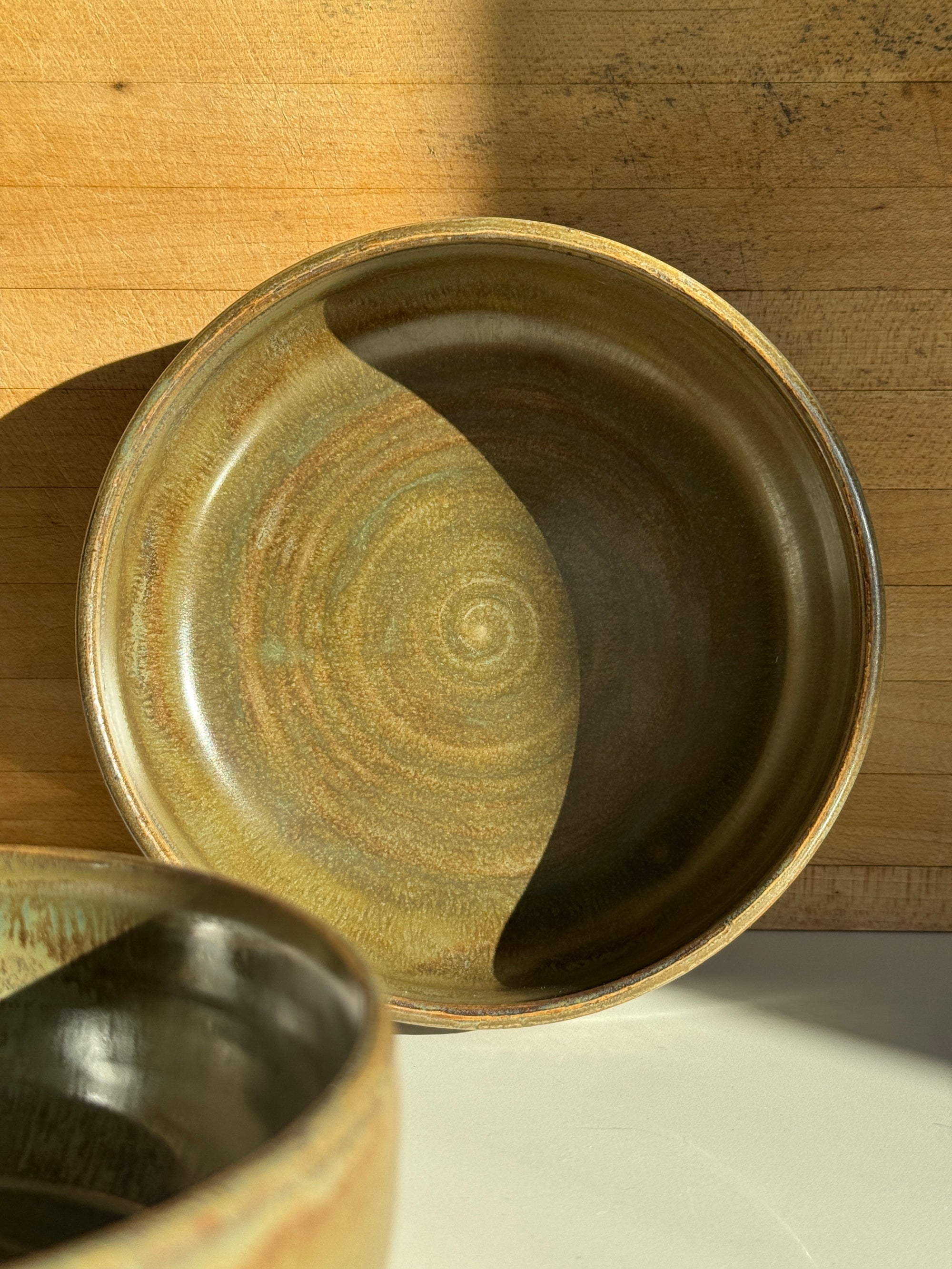 Close-up of a ceramic bowl with an olive glaze.
