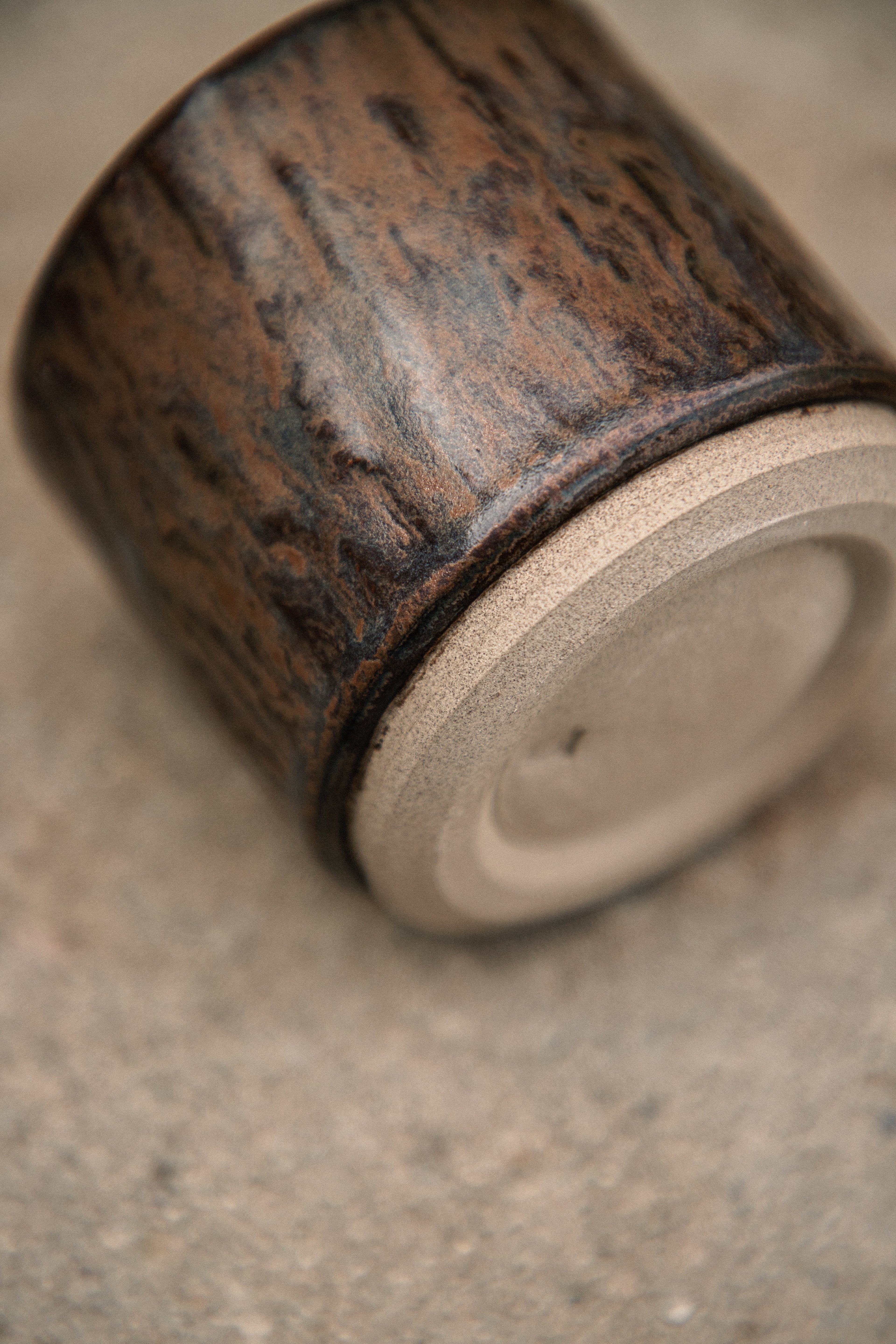 Close-up of a ceramic container with a textured surface on a beige background